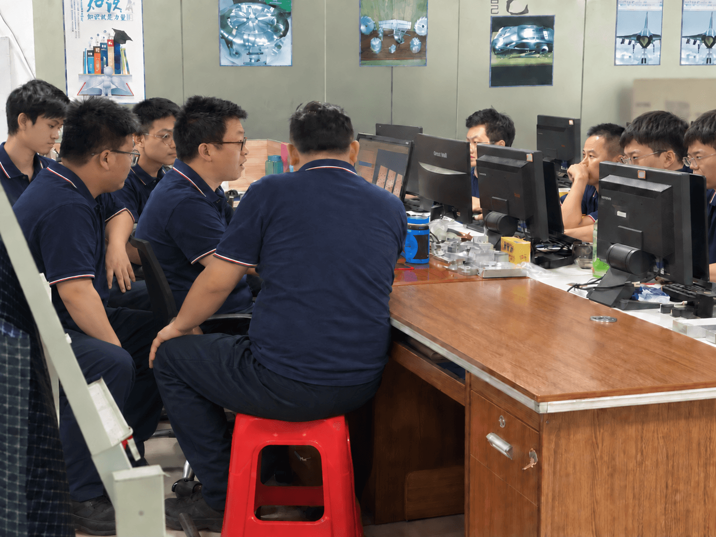 Engineering team reviewing drawings and CAD before customer approval