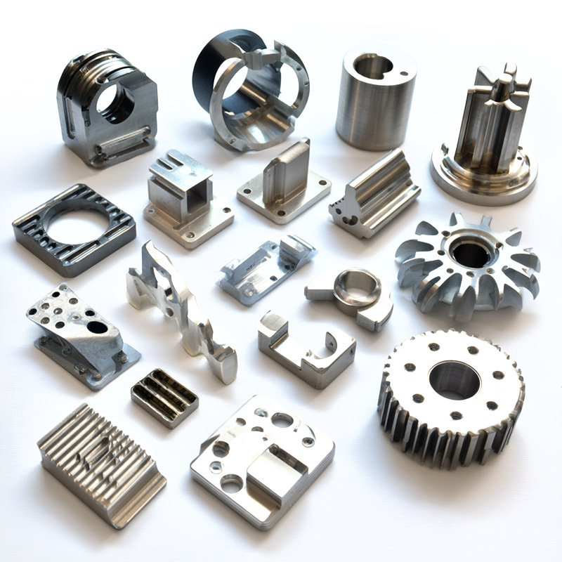 Group of custom metal components with milled pockets, ribs and cylindrical features