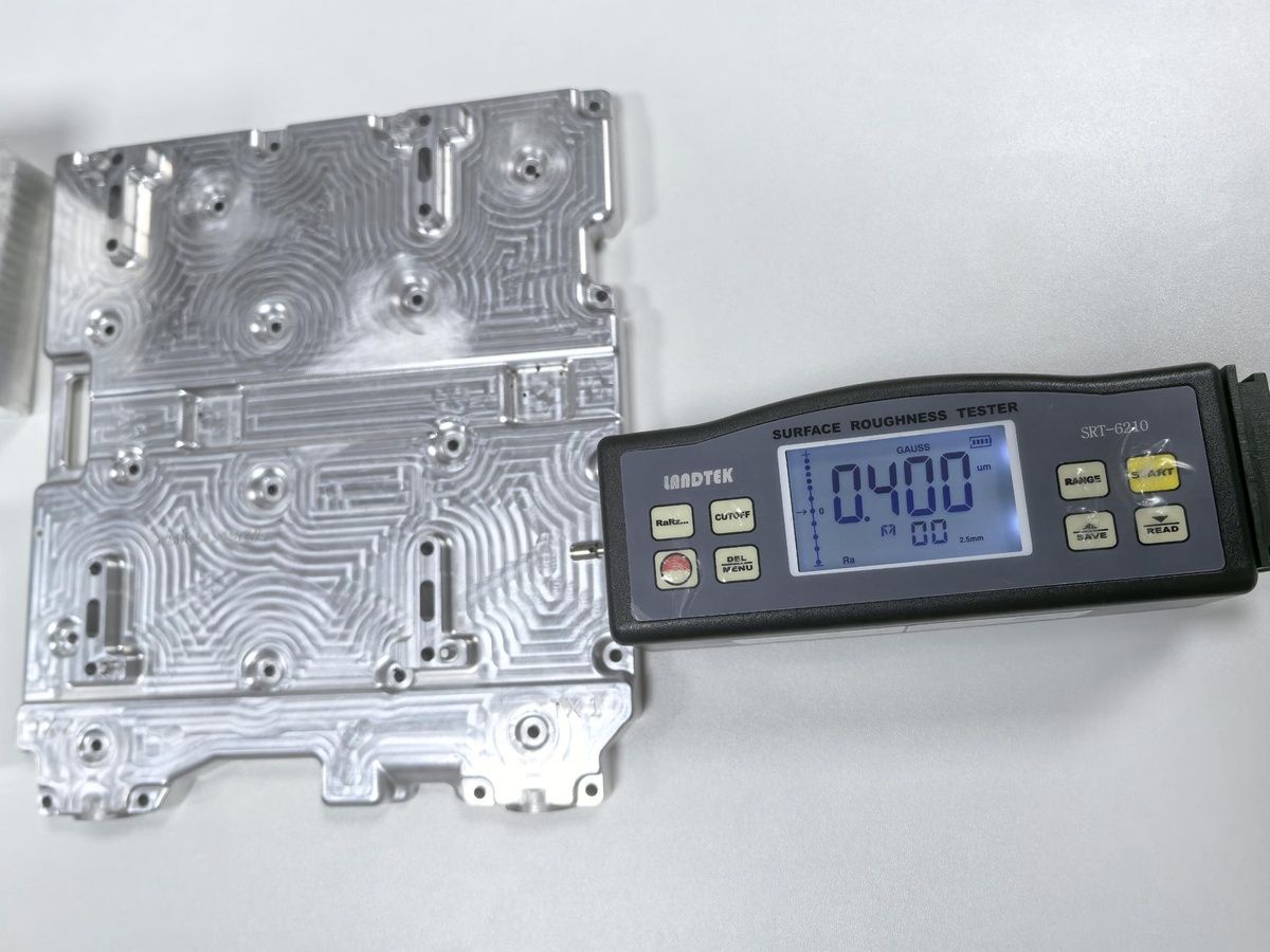 Surface roughness tester checking a machined metal surface